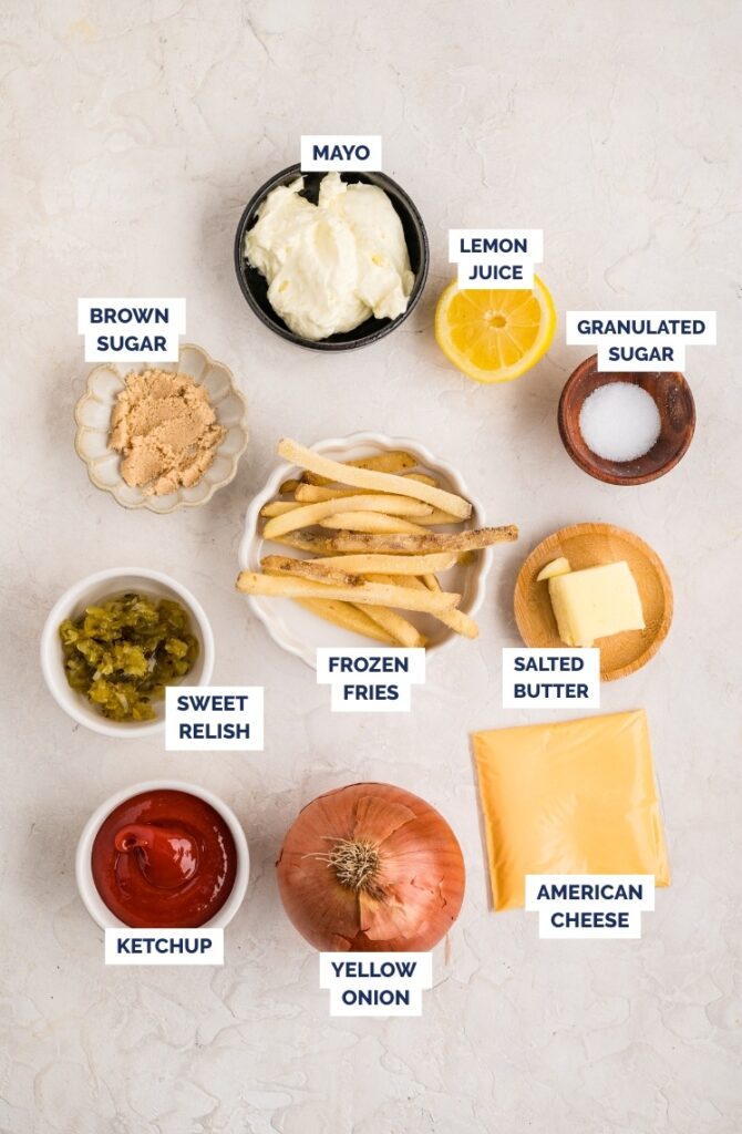 Animal fries ingredients laid out on a counter, including frozen fries, mayo, ketchup, sweet relish, onions, American cheese, butter, and seasonings.