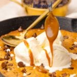 Close-up of a warm skillet chocolate chip cookie topped with scoops of vanilla ice cream and drizzled caramel sauce, with text overlay reading ‘Skillet Chocolate Chip Cookie – Real Balanced.’ A spoon hovers above, about to drizzle more caramel.