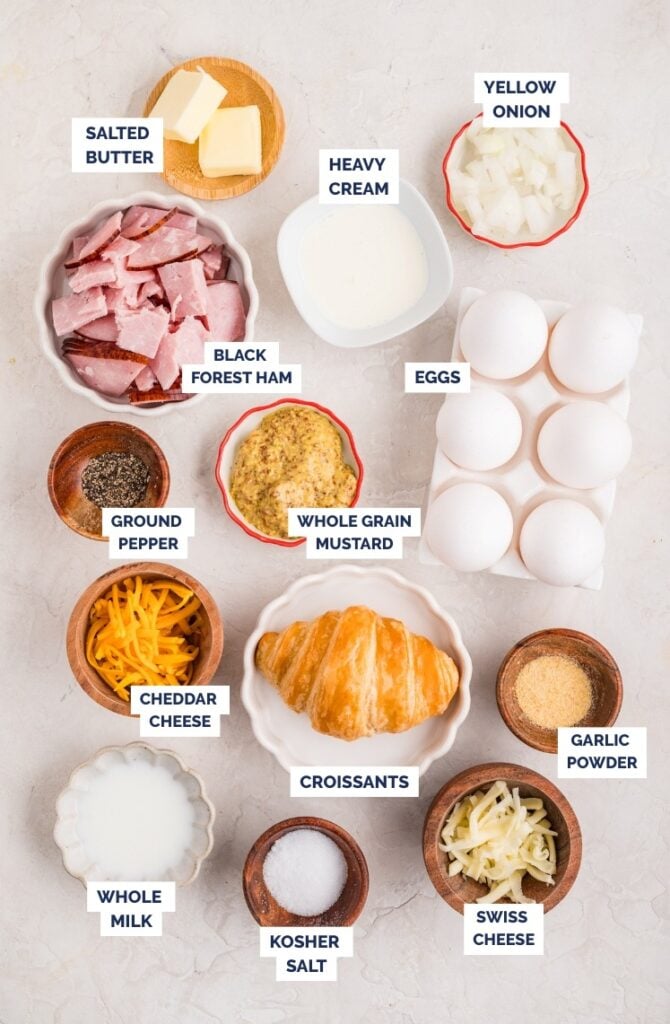 Ingredients for ham and cheese croissant breakfast bake arranged on a countertop.