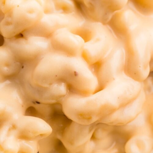 Close-up of creamy macaroni and cheese, showing elbow pasta coated in thick, melted cheese sauce.