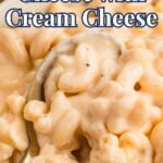 Close-up of creamy macaroni and cheese in a bowl with a spoon, topped with the text "Mac and Cheese with Cream Cheese.