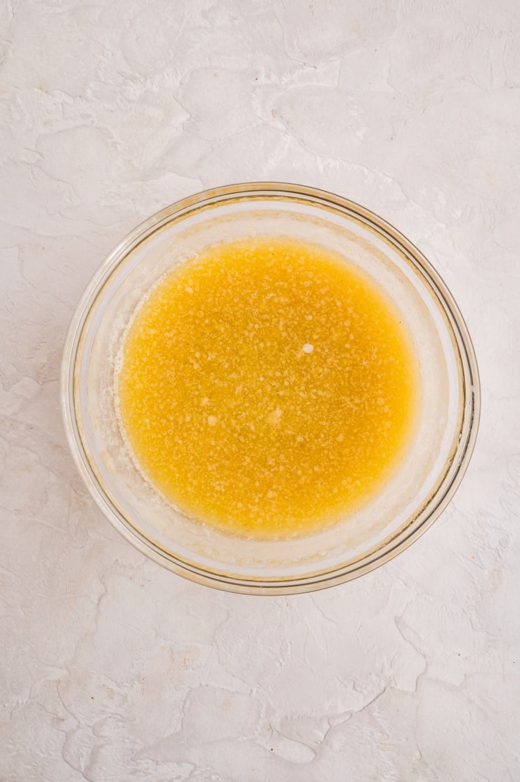 View of a glass bowl filled with melted yellow butter