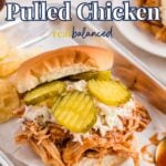 A Slow Cooker Pulled Chicken sandwich with coleslaw and pickles on a bun, served on a tray with chips. Text reads "Slow Cooker Pulled Chicken" and "real balanced.