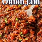 A skillet filled with bacon onion jam, garnished with chopped herbs, with a spoon resting in the mixture.