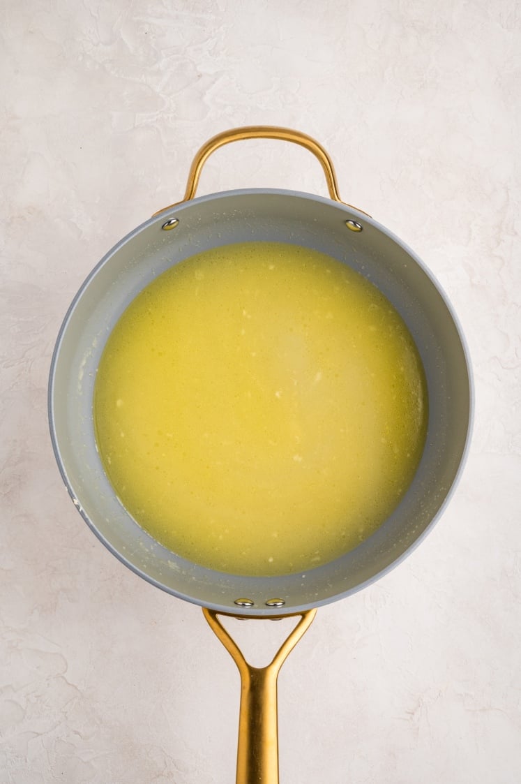 Broth poured into the pan after sautéing onion and garlic.