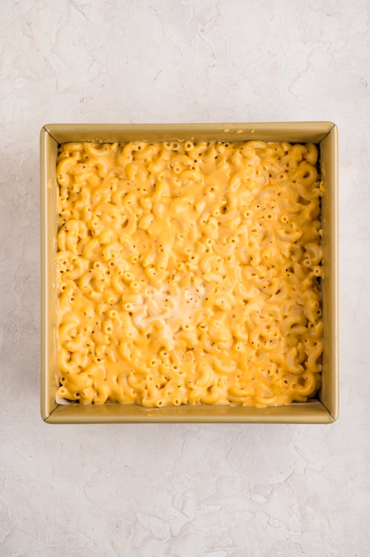Mac and cheese chilled until firm in a square pan before cutting.