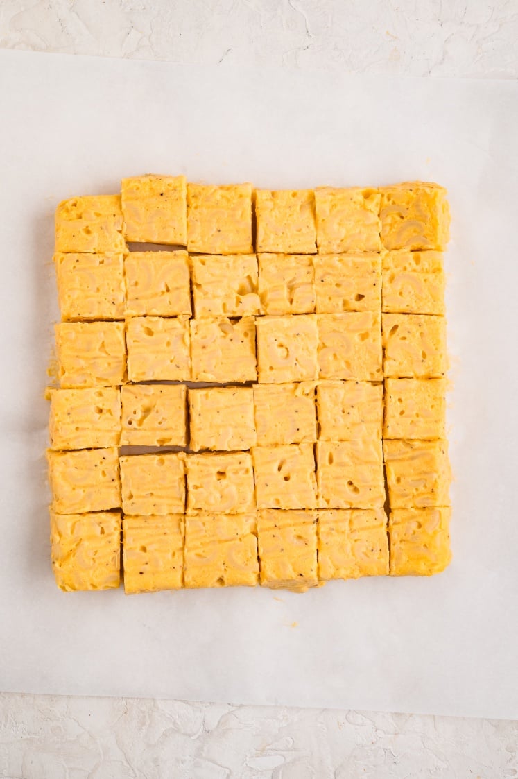 Chilled mac and cheese cut into evenly sized squares.