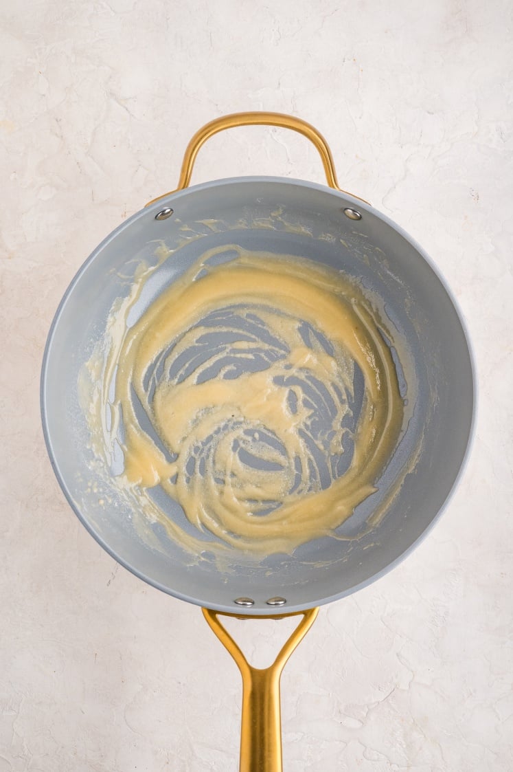 Roux cooked until smooth and pale in a saucepan.