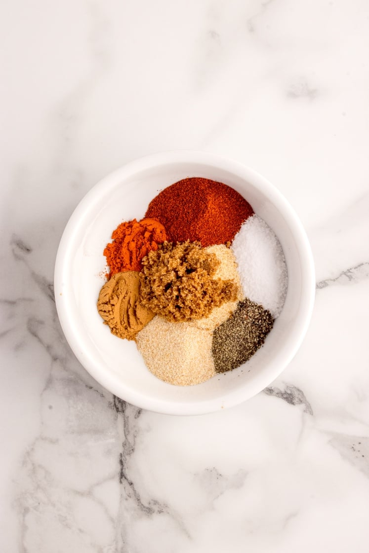 Small white bowl filled with a variety of brisket seasoning spices.