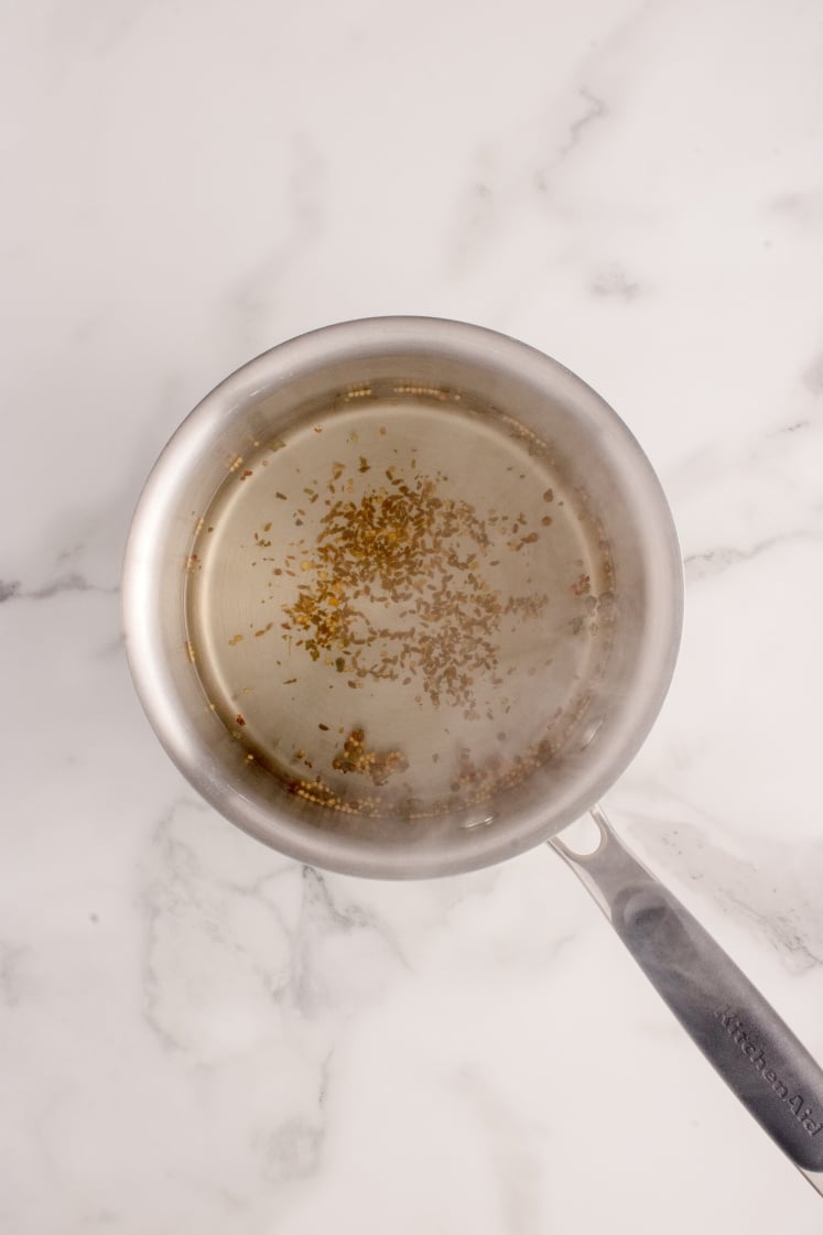 Spices simmering in a saucepan.