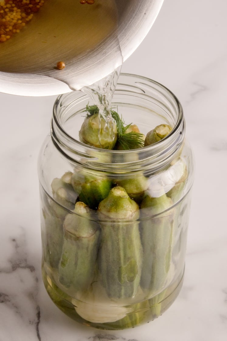 Brine poured into a jar of okra.