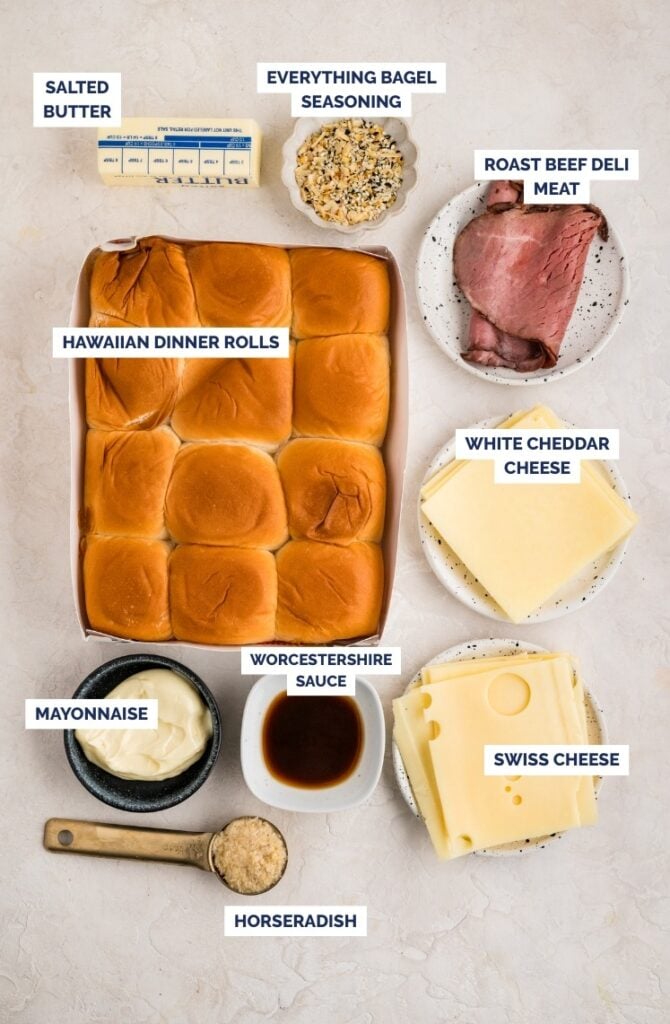 Ingredients for roast beef sliders, including Hawaiian rolls, roast beef, white cheddar, Swiss cheese, mayonnaise, horseradish, Worcestershire sauce, salted butter, and bagel seasoning.