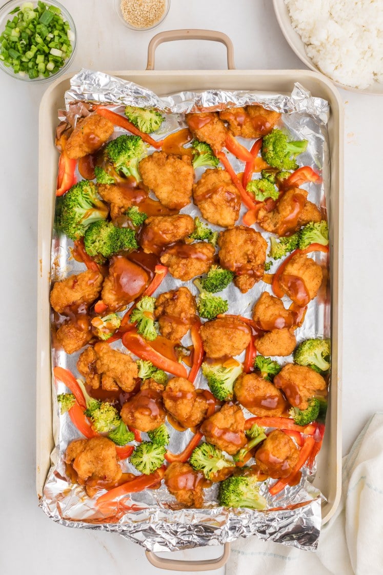 General Tso’s chicken baked with broccoli and red bell peppers on a sheet pan.”