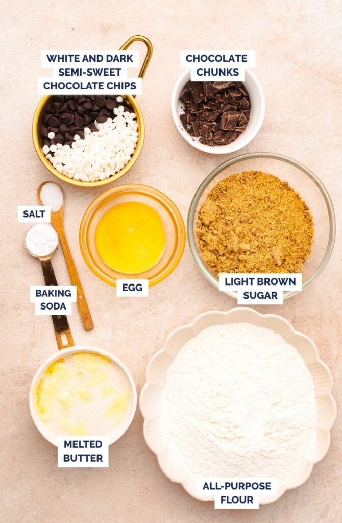 Skillet chocolate chip cookie ingredients including flour, brown sugar, melted butter, egg, chocolate chips, and baking soda.