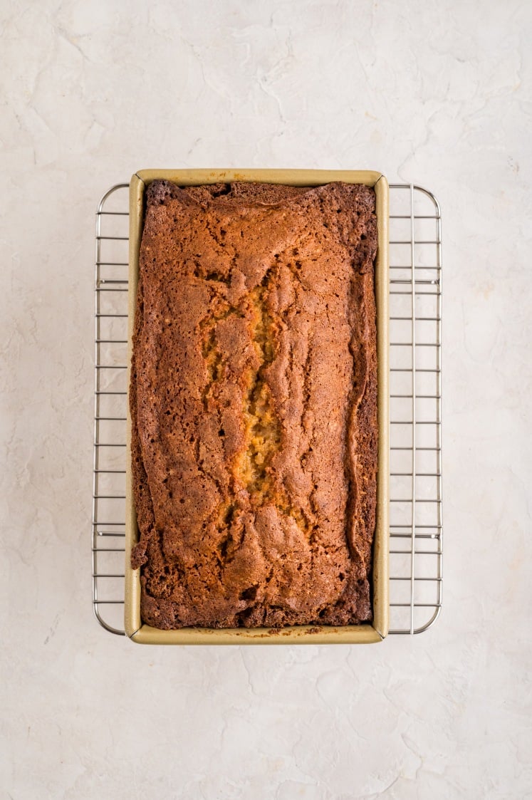 Baked sweet potato loaf cooling in the pan on a wire rack.