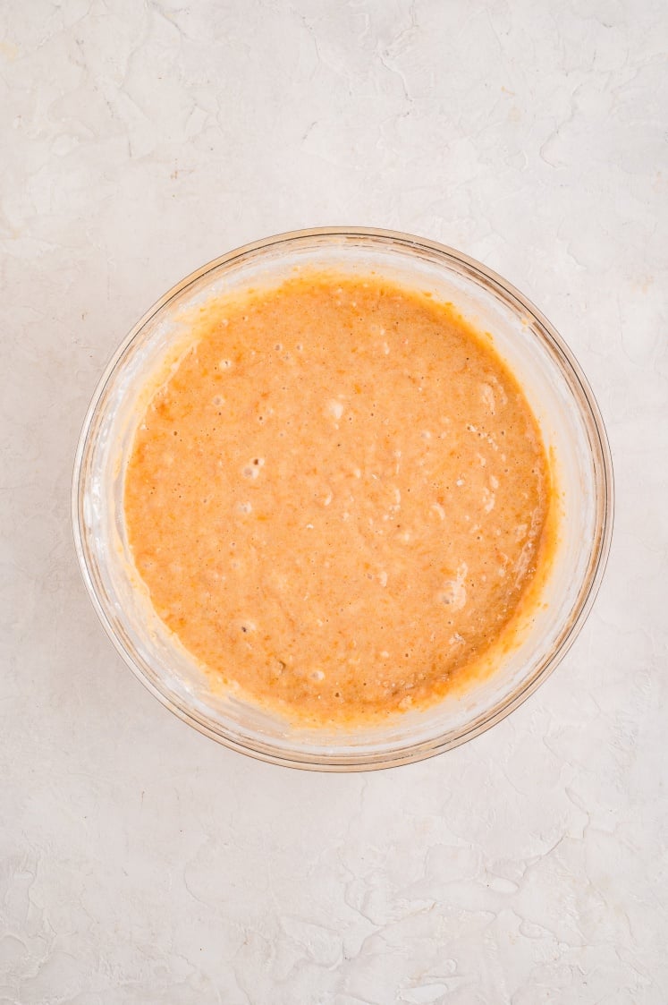 Sweet potato loaf batter mixed in a glass bowl.