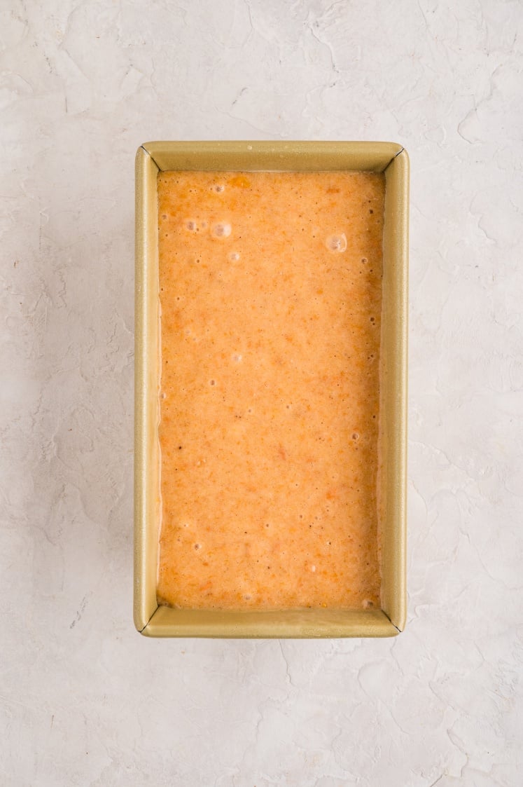 Sweet potato loaf batter poured into a loaf pan.