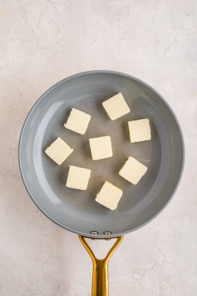 Cubed butter in a skillet.