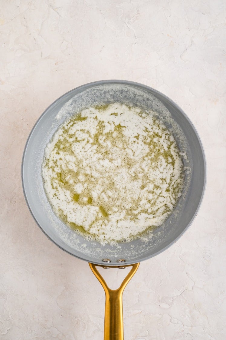 Butter and sugar melted together in a skillet.