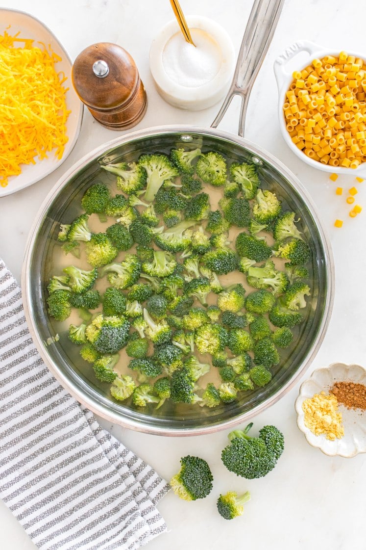 Large skillet filled with broccoli florets.
