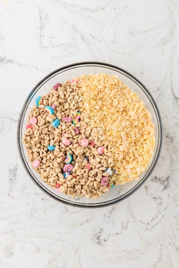 Lucky Charms cereal and Rice Krispies cereal mixed in a bowl.