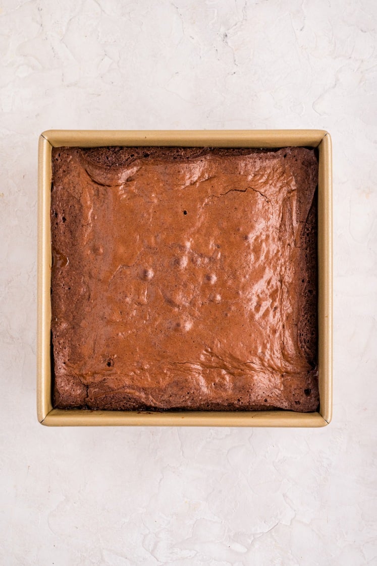 The brownies fully baked with a crackly top, ready to cool before slicing into rich peppermint-stuffed squares.