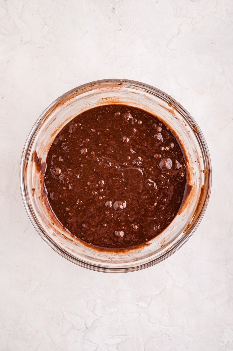 The brownie batter fully mixed and smooth, thick and glossy, with just a few bubbles on the surface—ready for the next step.