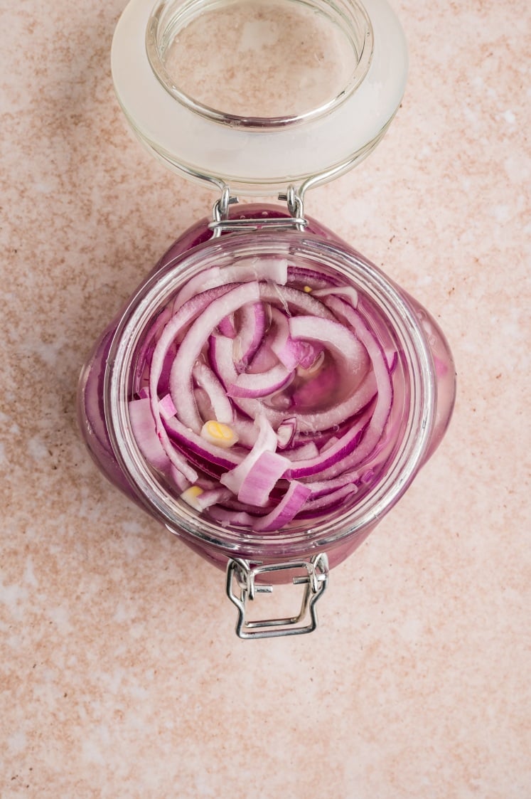 The onions have started to turn that soft pink, and you can see them relaxing into the brine.