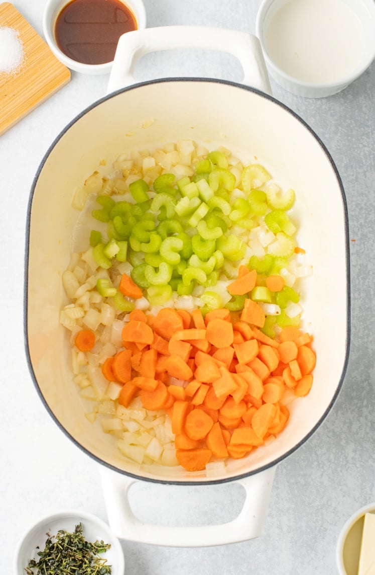 Chopped carrots and celery added to the pot with the onions, cooking down until slightly tender and aromatic.