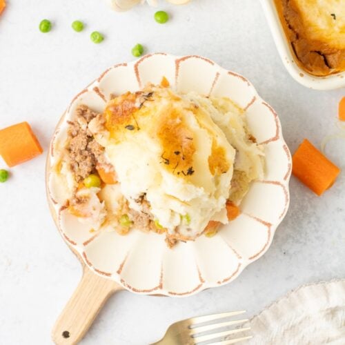 A cozy scoop of shepherd’s pie served up on a small plate.