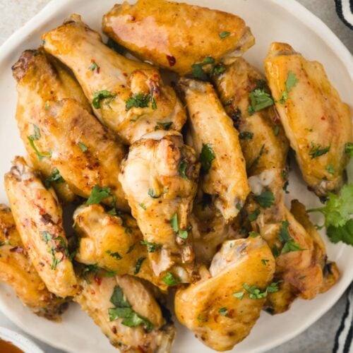 Air fryer chicken wings on a white plate.